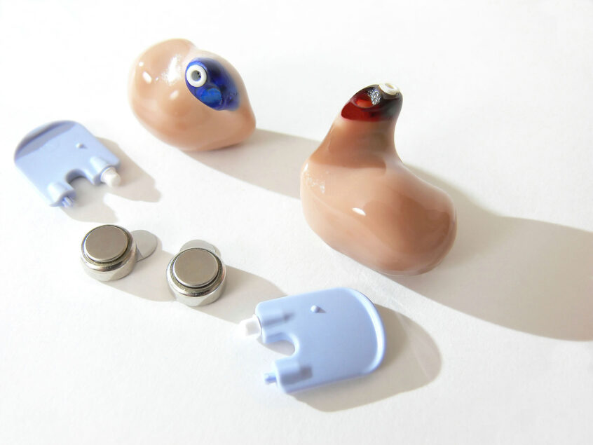 A modern "in the ear" hearing aid for the left and right ear with batteries
